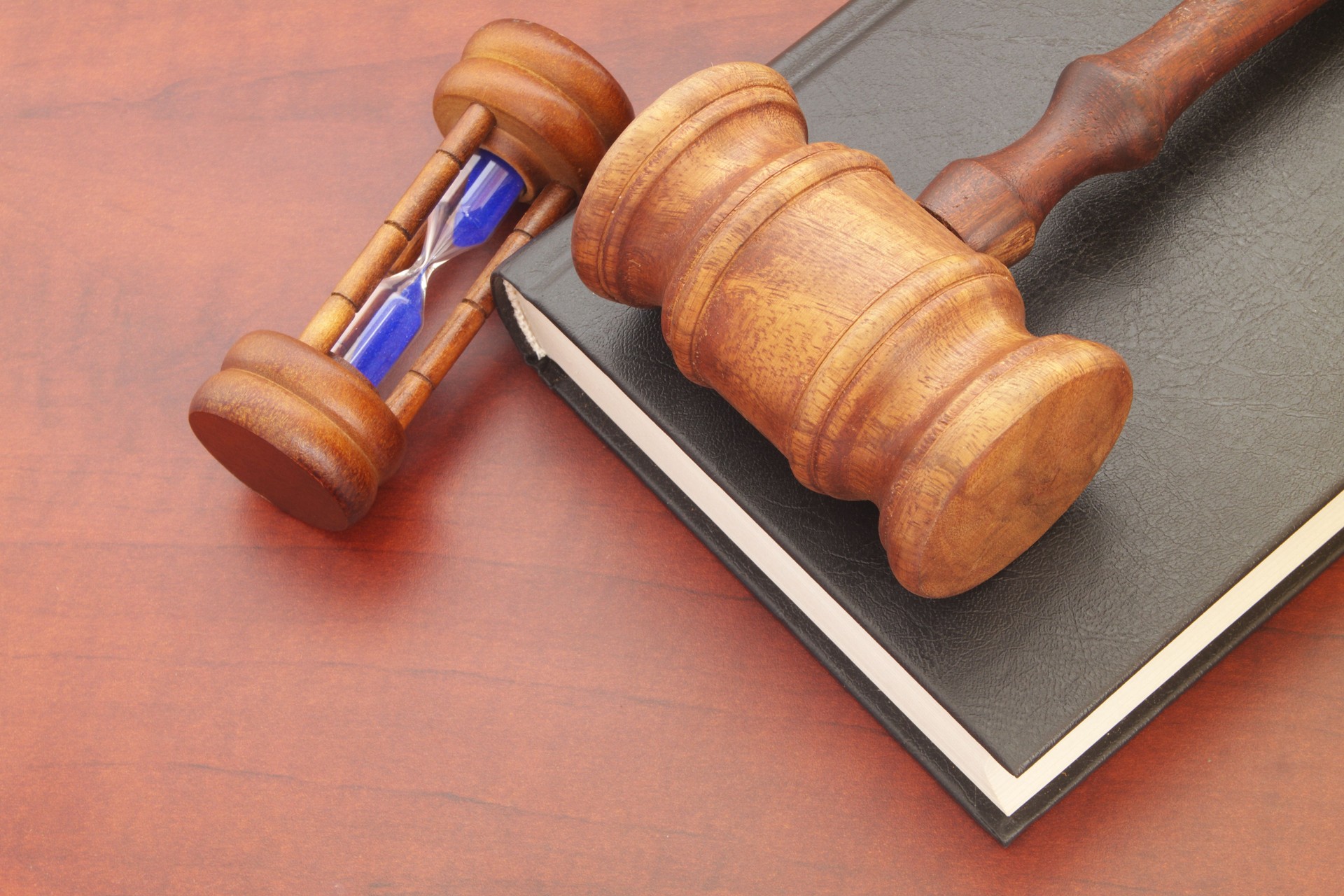 Judge gavel, hourglass and legal book