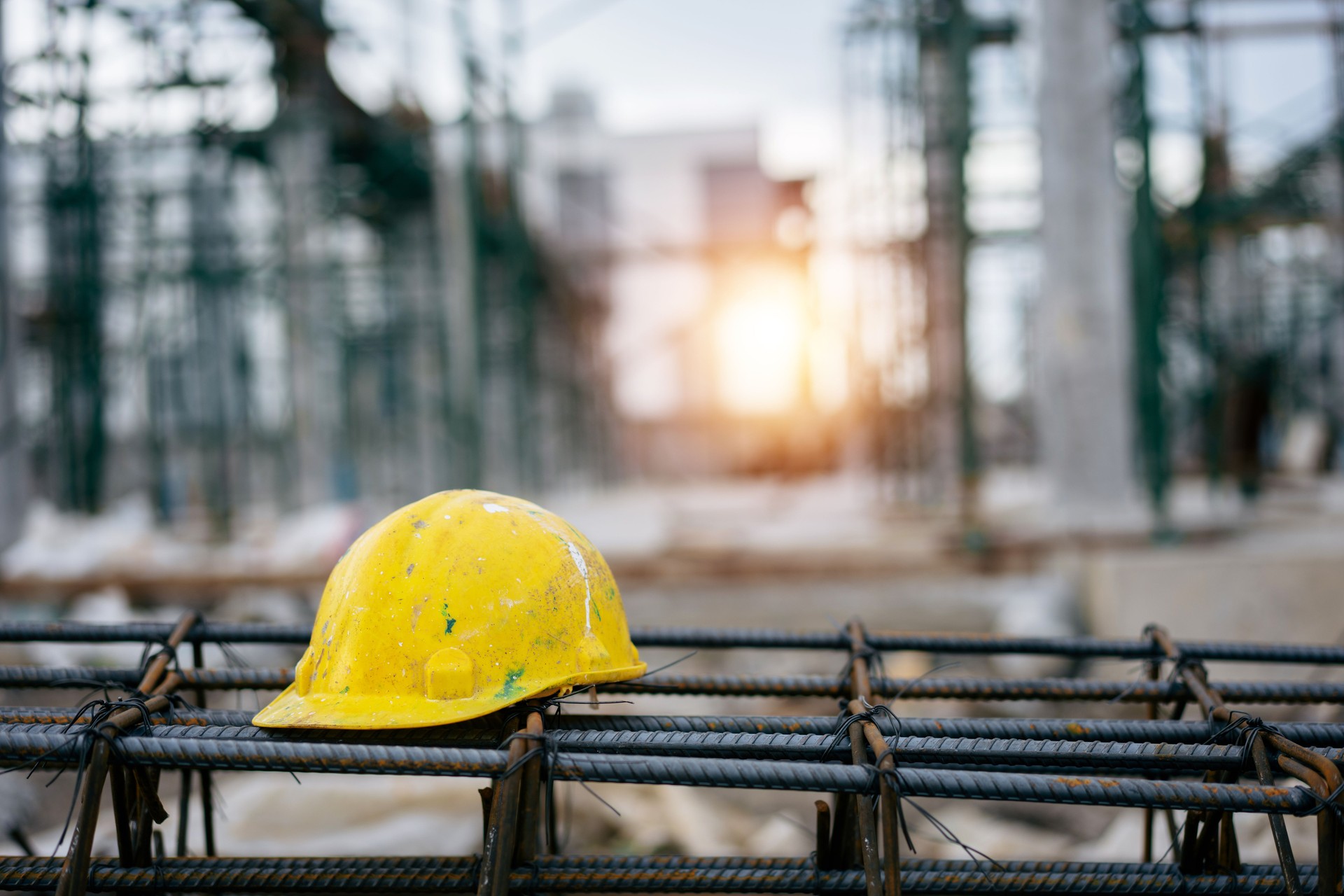 Yellow and white helmets for worker on the Steel frame in factory construction site, contractor, real estate business, safety first concept.