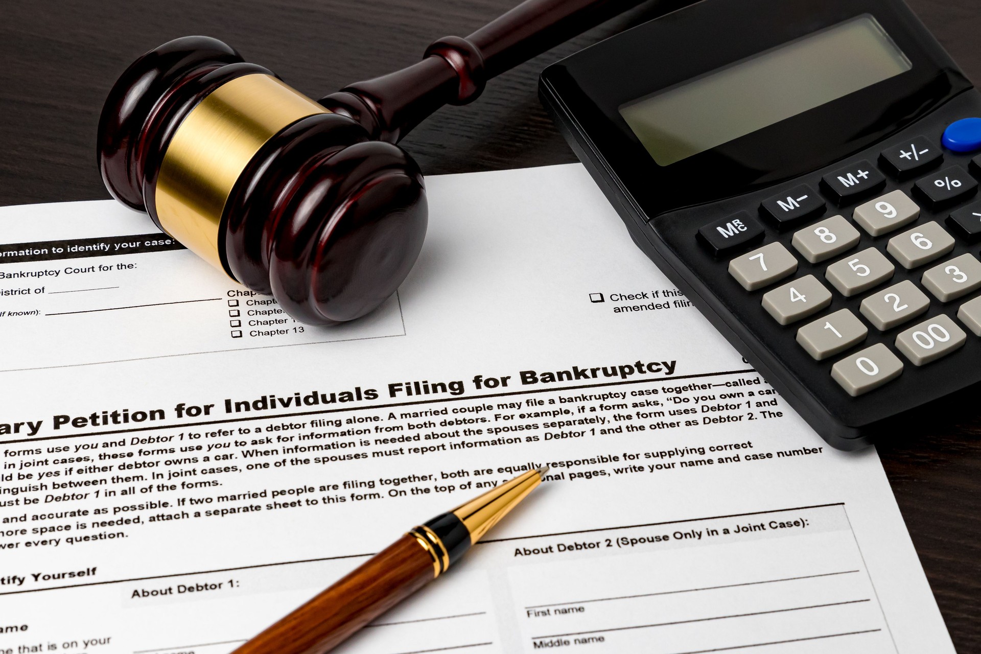 Bankruptcy petition for individuals with calculator and gavel. Concept of financial and unemployment crisis, personal debt, economy and recession.